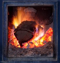 Log on fire in wood stove (Timberline stove)